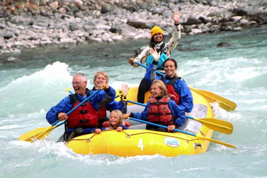 Whitewater rafting on the Athabasca River in Jasper after the wildfires, with rafters floating through glacier-fed mountain scenery